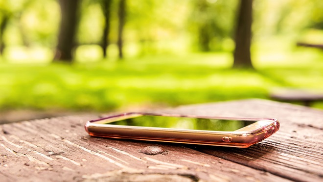 forgotten smartphone left on table in park